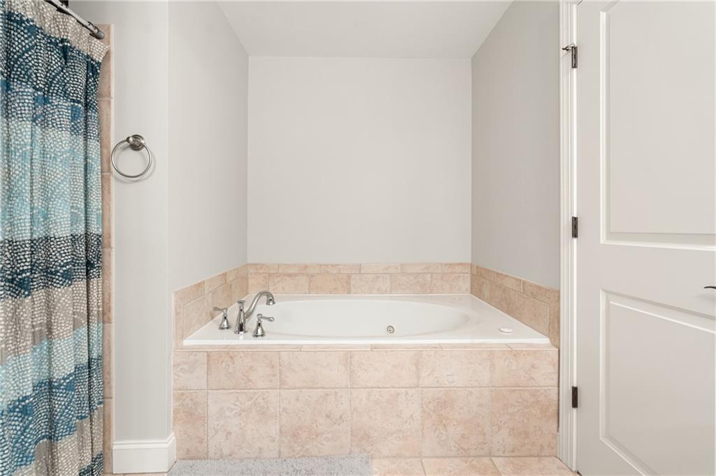 2015 Eagle Ridge Roswell, GA 30076 - Photo 23 of 47 a bathroom with a bathtub and shower