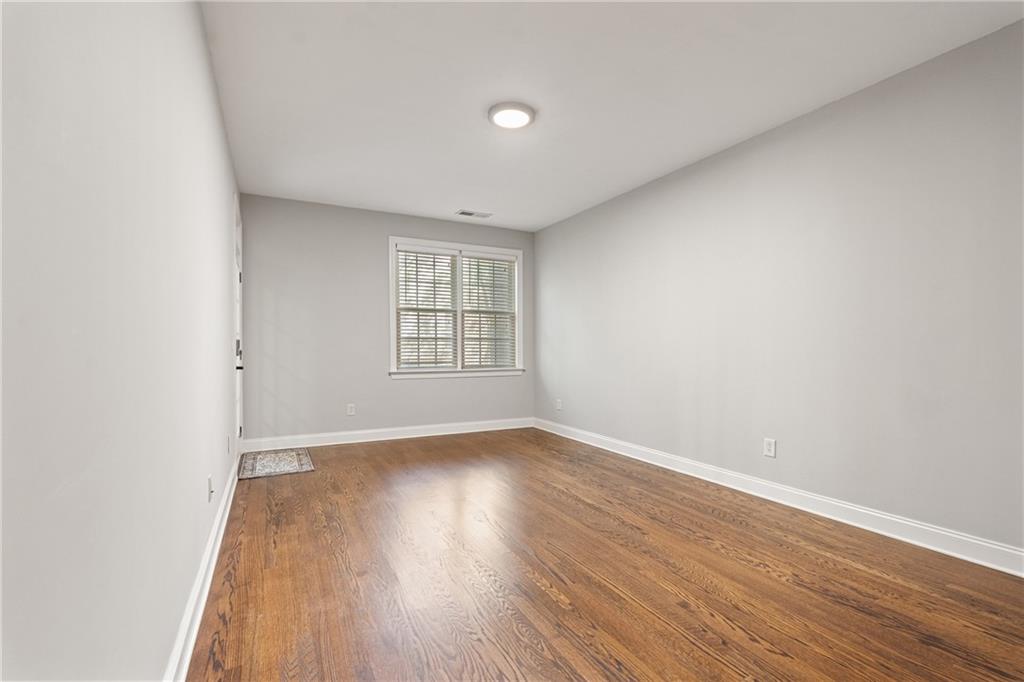 2015 Eagle Ridge Roswell, GA 30076 - Photo 26 of 47 an empty room with wooden floor and windows