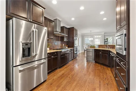 a kitchen with stainless steel appliances and refrigerator