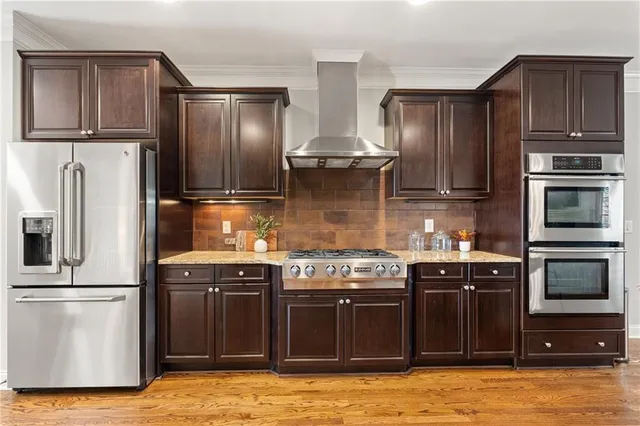 a kitchen with stainless steel appliances granite countertop a refrigerator stove and sink