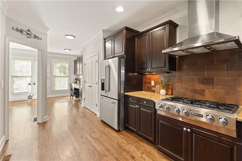a kitchen with wooden cabinets and stainless steel appliances