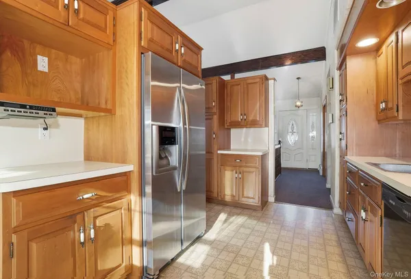 a kitchen with stainless steel appliances granite countertop a refrigerator and a sink
