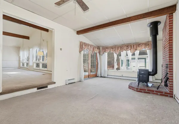a living room with furniture and large windows