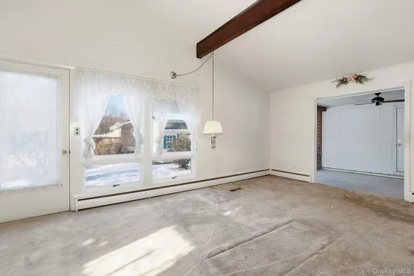 a view of an empty room with a fireplace