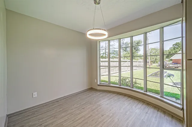 a view of a room with wooden floor and large window