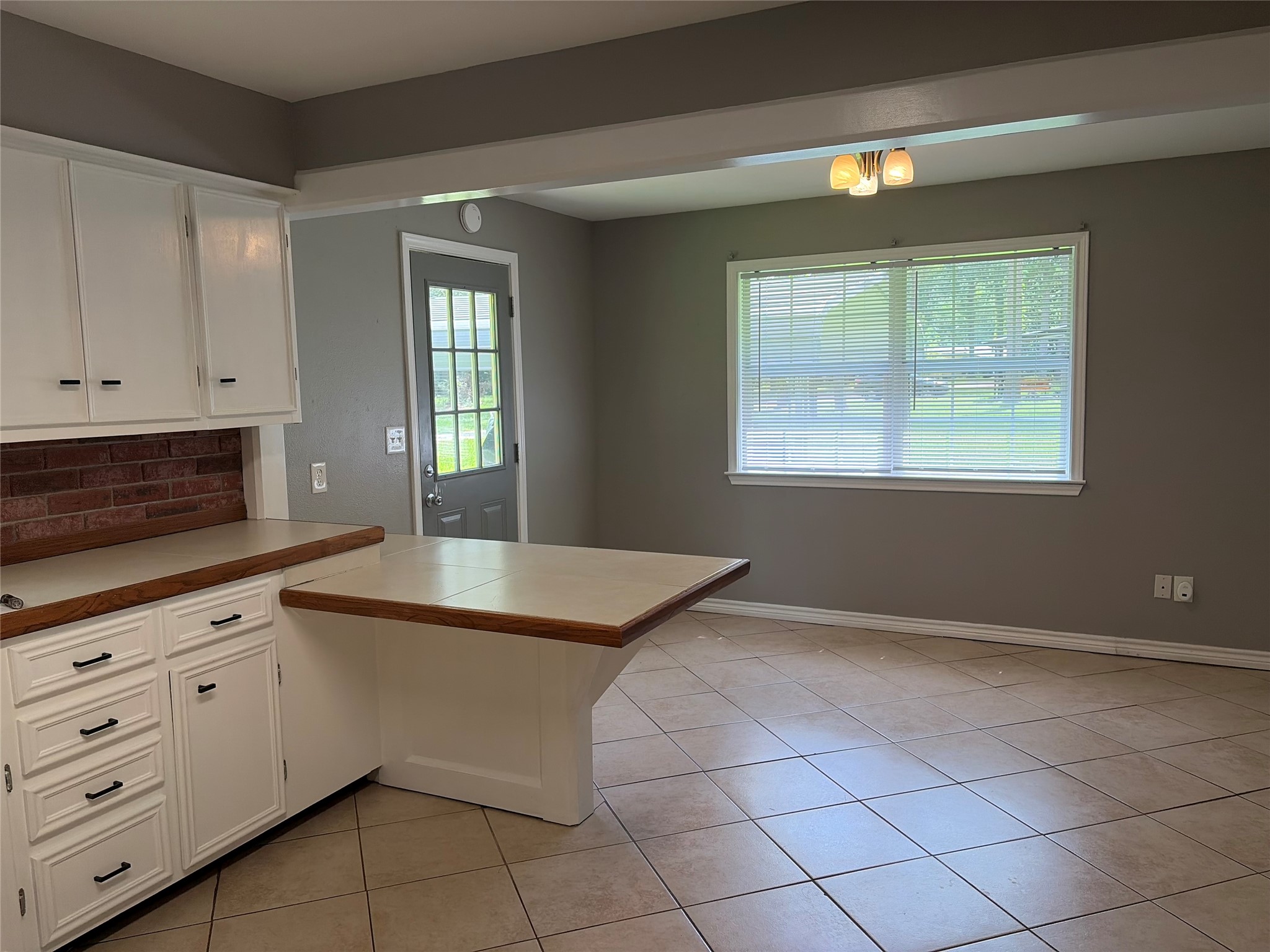 14529 Chapperal Pipeline Road, Unit A Conroe, TX 77302 - Photo 6 of 25 a kitchen with granite countertop white cabinets and window