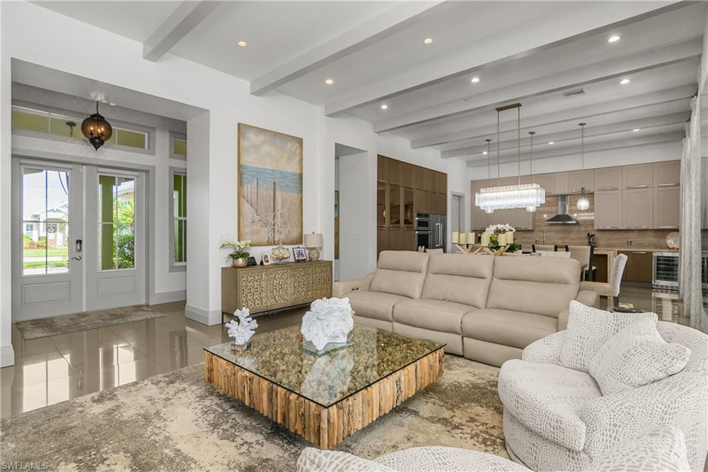 14852 Dockside Lane Naples, FL 34114 - Photo 11 of 49 a living room with furniture and a large window