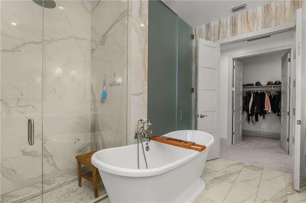 14852 Dockside Lane Naples, FL 34114 - Photo 15 of 49 a bathroom with a sink a toilet and shower