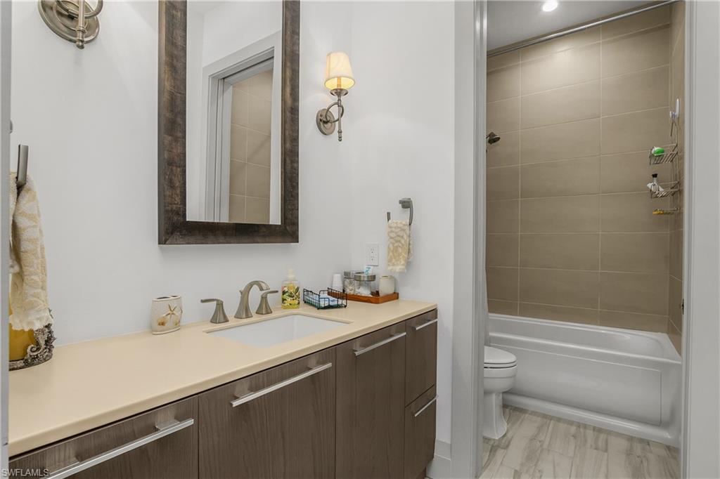 14852 Dockside Lane Naples, FL 34114 - Photo 18 of 49 a bathroom with a sink a toilet and shower