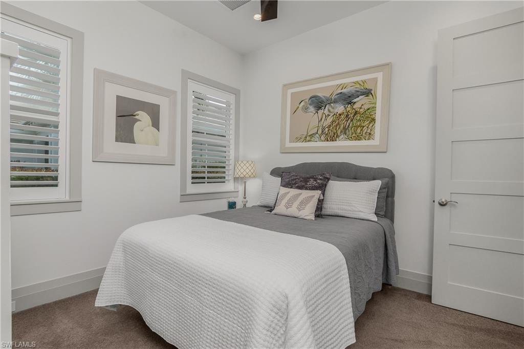 14852 Dockside Lane Naples, FL 34114 - Photo 19 of 49 a bedroom with a bed and a painting on the wall