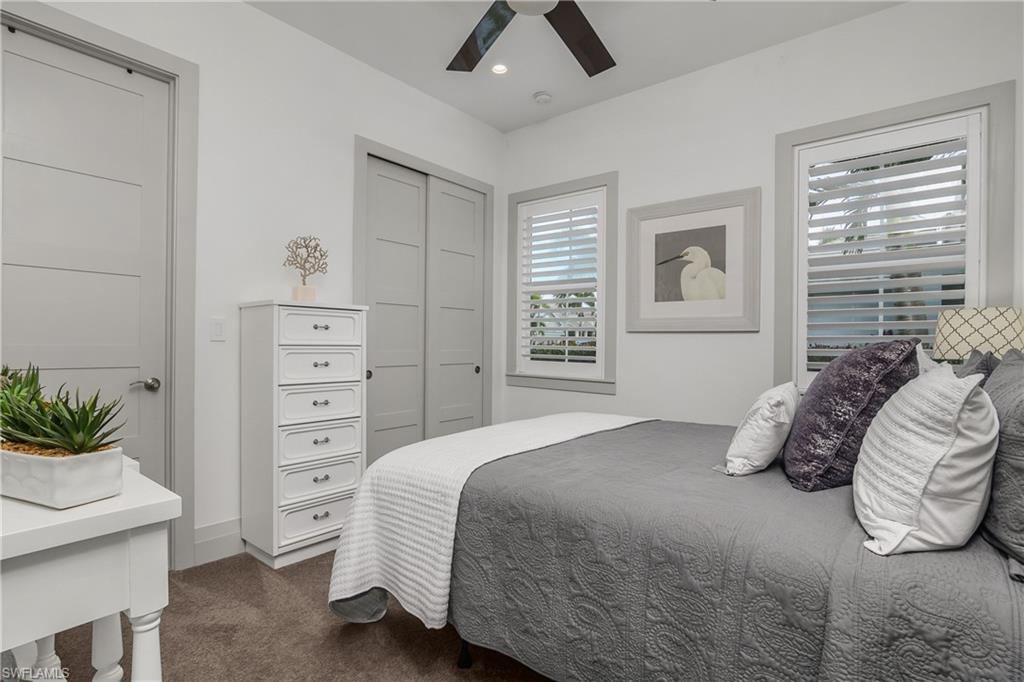 14852 Dockside Lane Naples, FL 34114 - Photo 20 of 49 a bedroom with a bed and a window