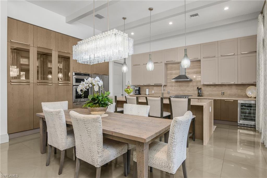 14852 Dockside Lane Naples, FL 34114 - Photo 2 of 49 a dining area with stainless steel appliances kitchen island a table and chairs