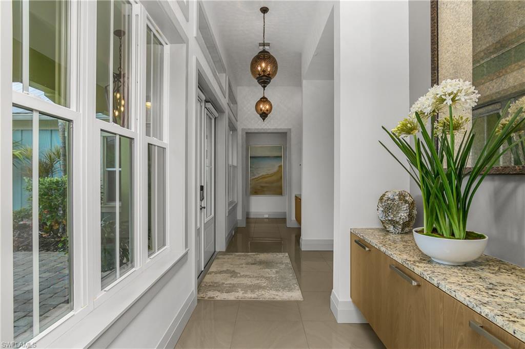 14852 Dockside Lane Naples, FL 34114 - Photo 25 of 49 a potted plant sitting on a floor in front of a door
