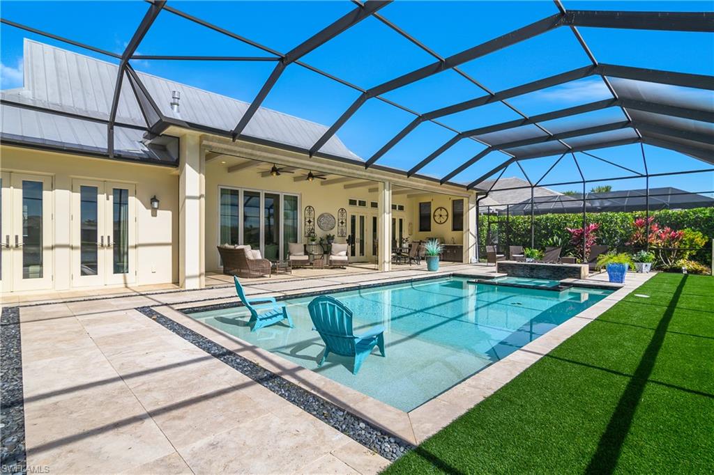 14852 Dockside Lane Naples, FL 34114 - Photo 29 of 49 a view of a backyard with a patio and fire pit