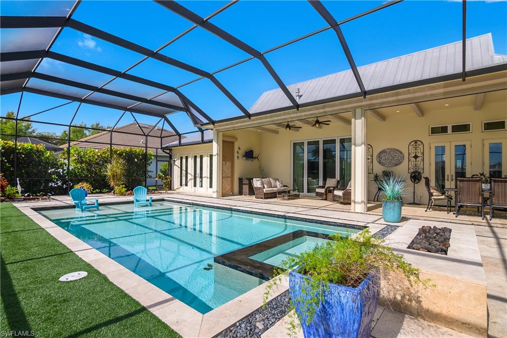 14852 Dockside Lane Naples, FL 34114 - Photo 30 of 49 a view of a swimming pool with a patio
