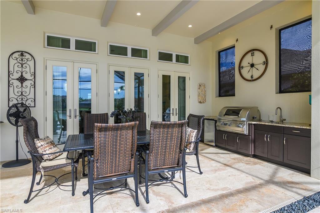 14852 Dockside Lane Naples, FL 34114 - Photo 32 of 49 a view of a dining room with furniture and a large window