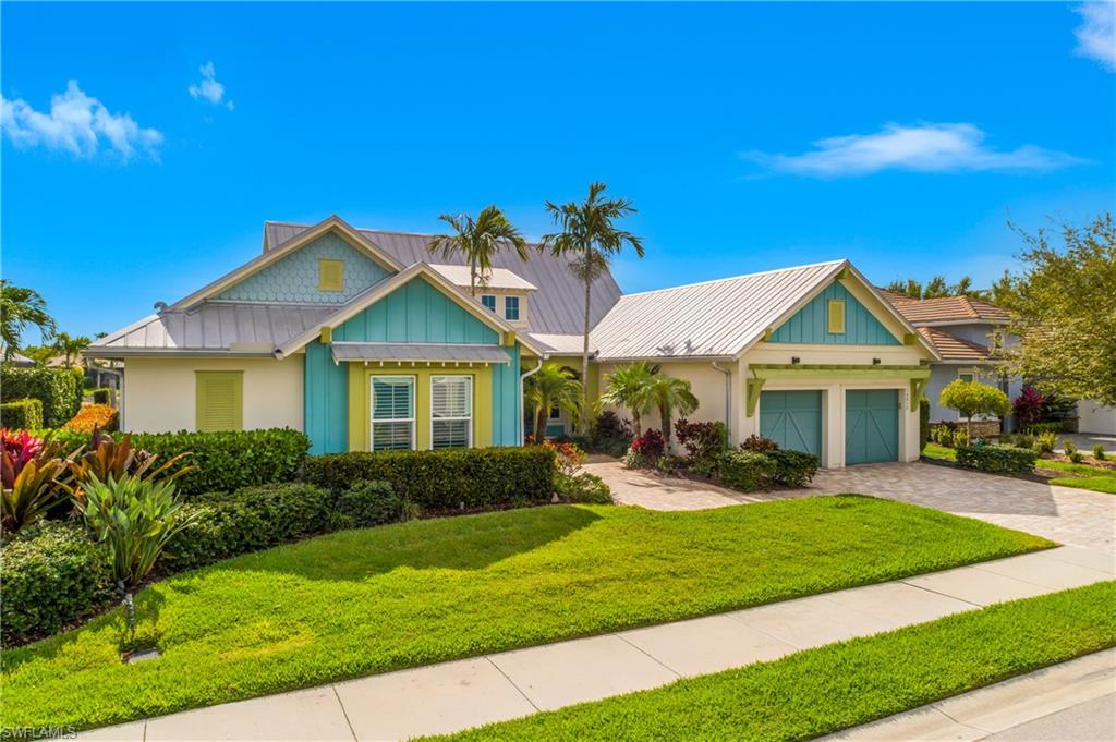 14852 Dockside Lane Naples, FL 34114 - Photo 38 of 49 a front view of a house with a yard and potted plants