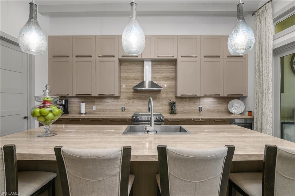 14852 Dockside Lane Naples, FL 34114 - Photo 6 of 49 a kitchen with a table chairs stove and cabinets