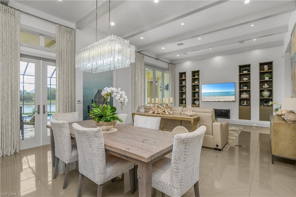 14852 Dockside Lane Naples, FL 34114 - Photo 7 of 49 a dining room with furniture a chandelier and window