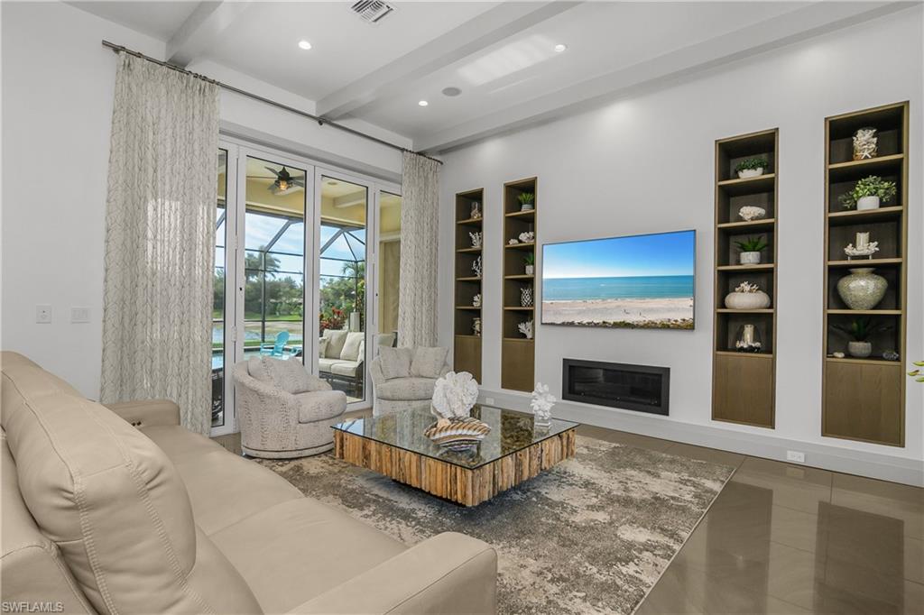 14852 Dockside Lane Naples, FL 34114 - Photo 8 of 49 a living room with furniture and a fireplace