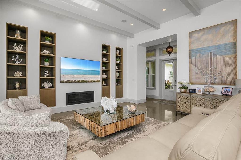 14852 Dockside Lane Naples, FL 34114 - Photo 9 of 49 a living room with furniture and a fireplace