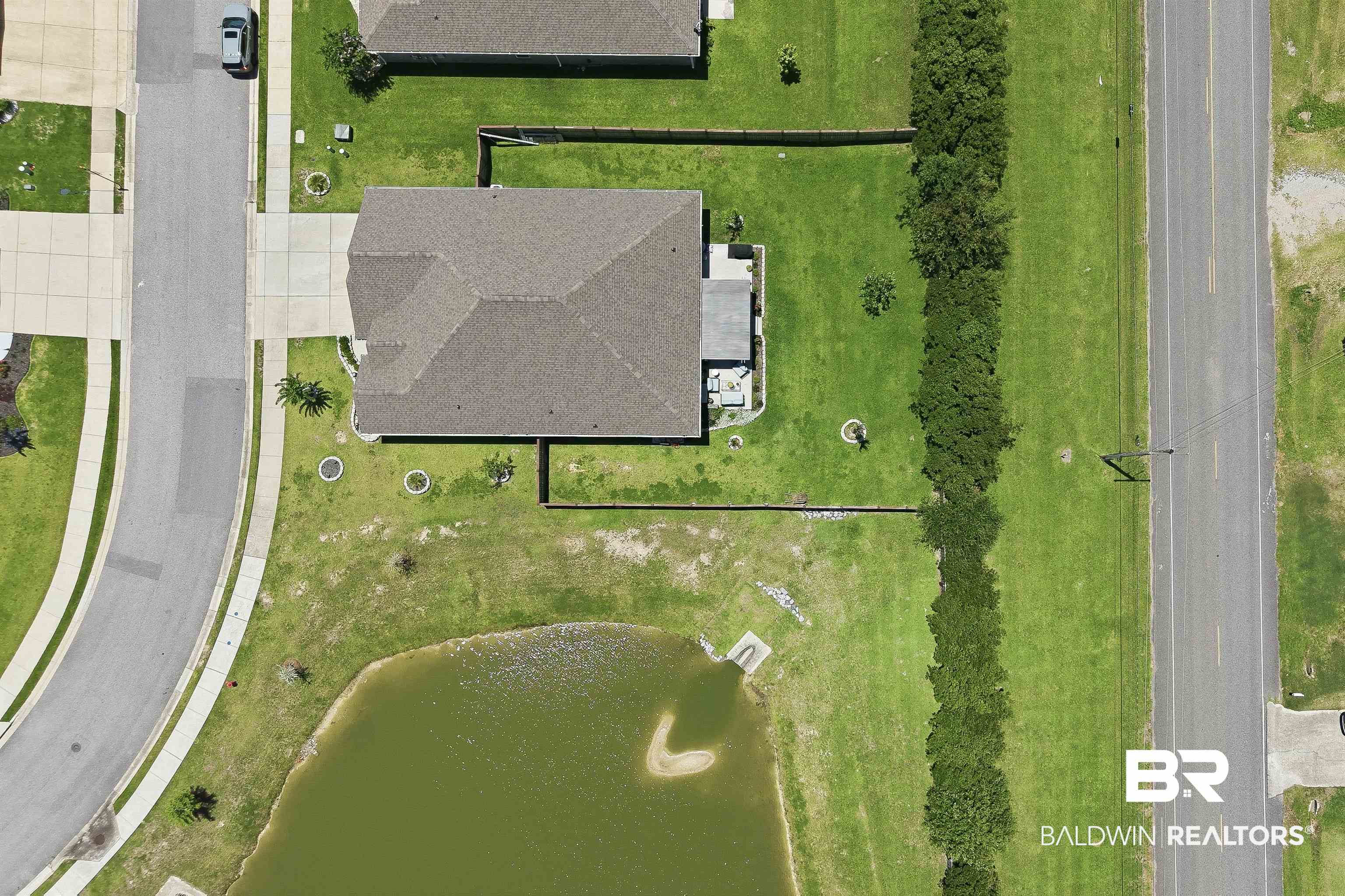 8735 Bronze Lane Foley, AL 36535 - Photo 58 of 58 Property featuring a shingle roof, paved driveway, and established green lawn