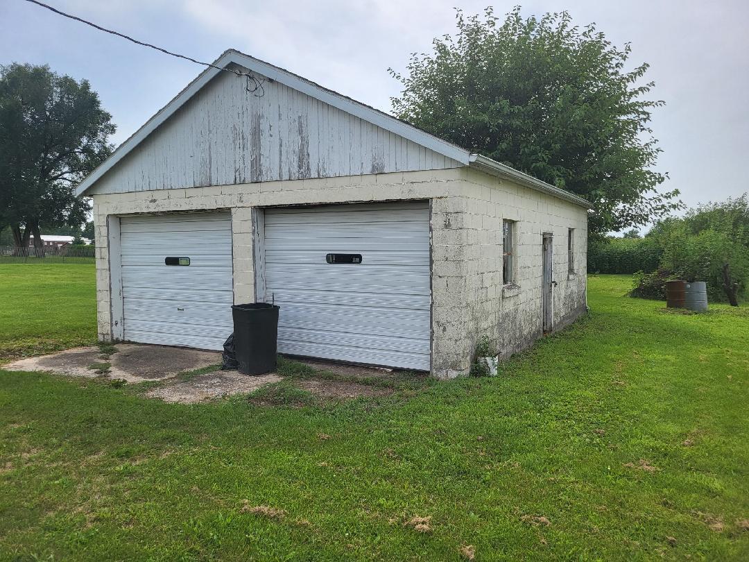 237 North Main Street Roberts, IL 60962 - Photo 2 of 11 a view of a backyard with brick wall and a large tree