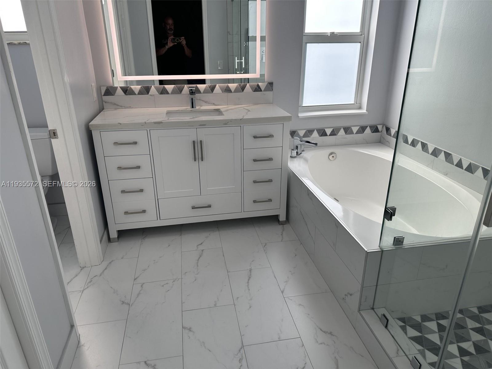 The Ridges Weston, FL 33331 - Photo 14 of 28 a bathroom with a sink and a mirror