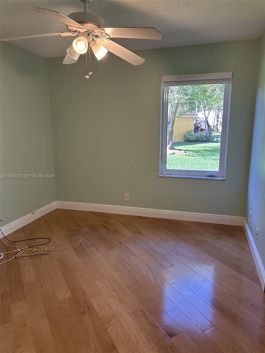 The Ridges Weston, FL 33331 - Photo 18 of 28 an empty room with wooden floor and windows