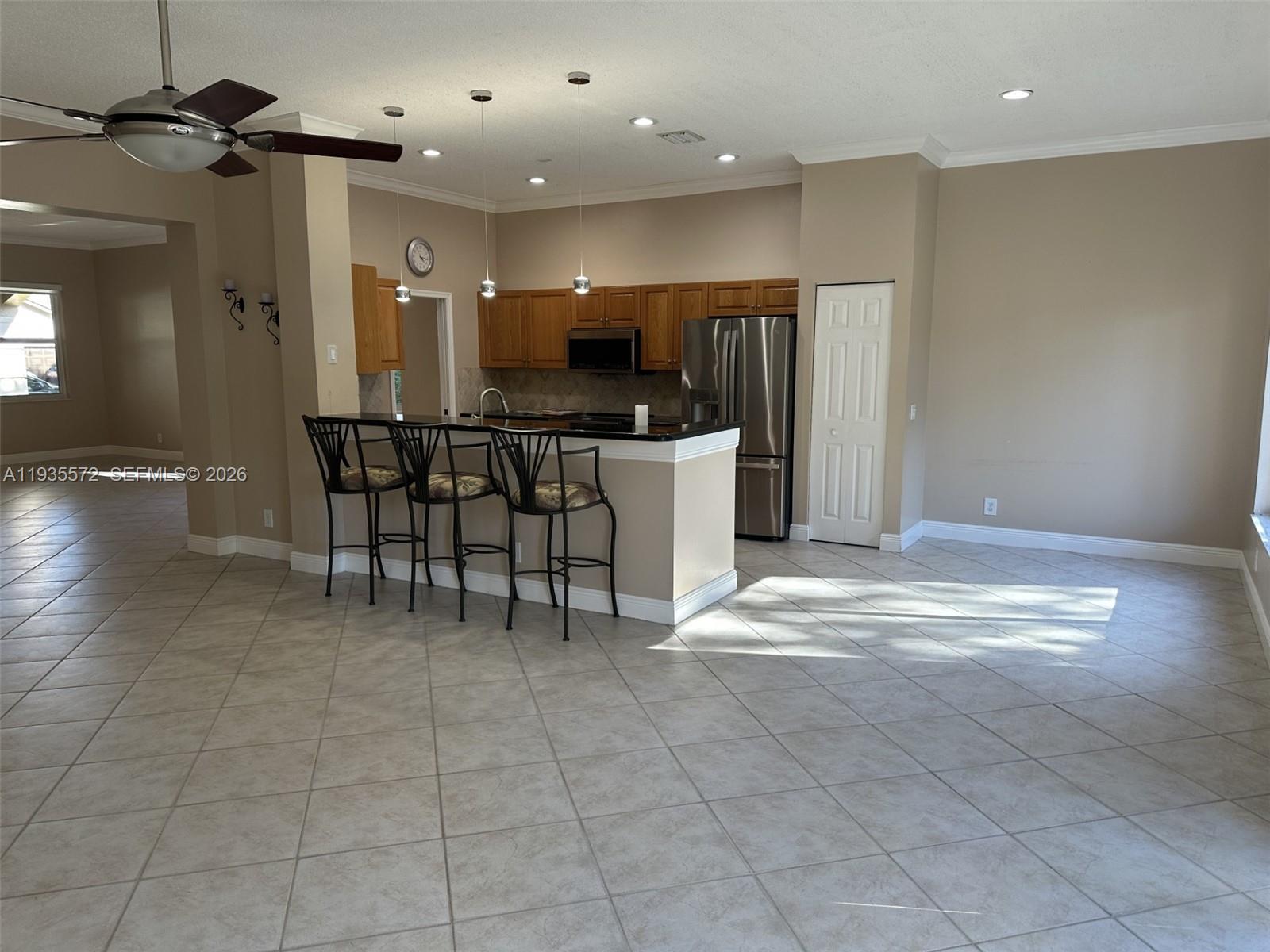 The Ridges Weston, FL 33331 - Photo 4 of 28 a view of kitchen with refrigerator and chairs