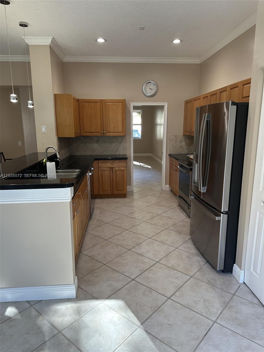 The Ridges Weston, FL 33331 - Photo 6 of 28 a kitchen with a sink a refrigerator and cabinets
