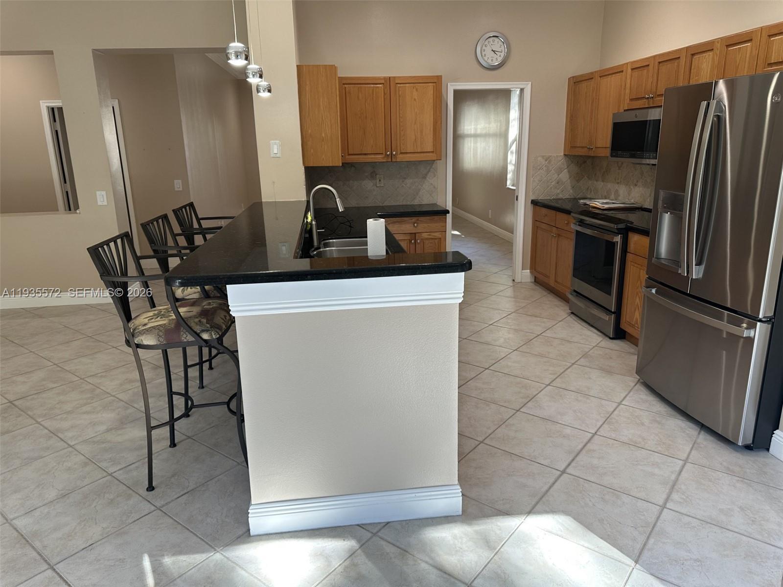 The Ridges Weston, FL 33331 - Photo 7 of 28 a kitchen with stainless steel appliances granite countertop a refrigerator and a stove