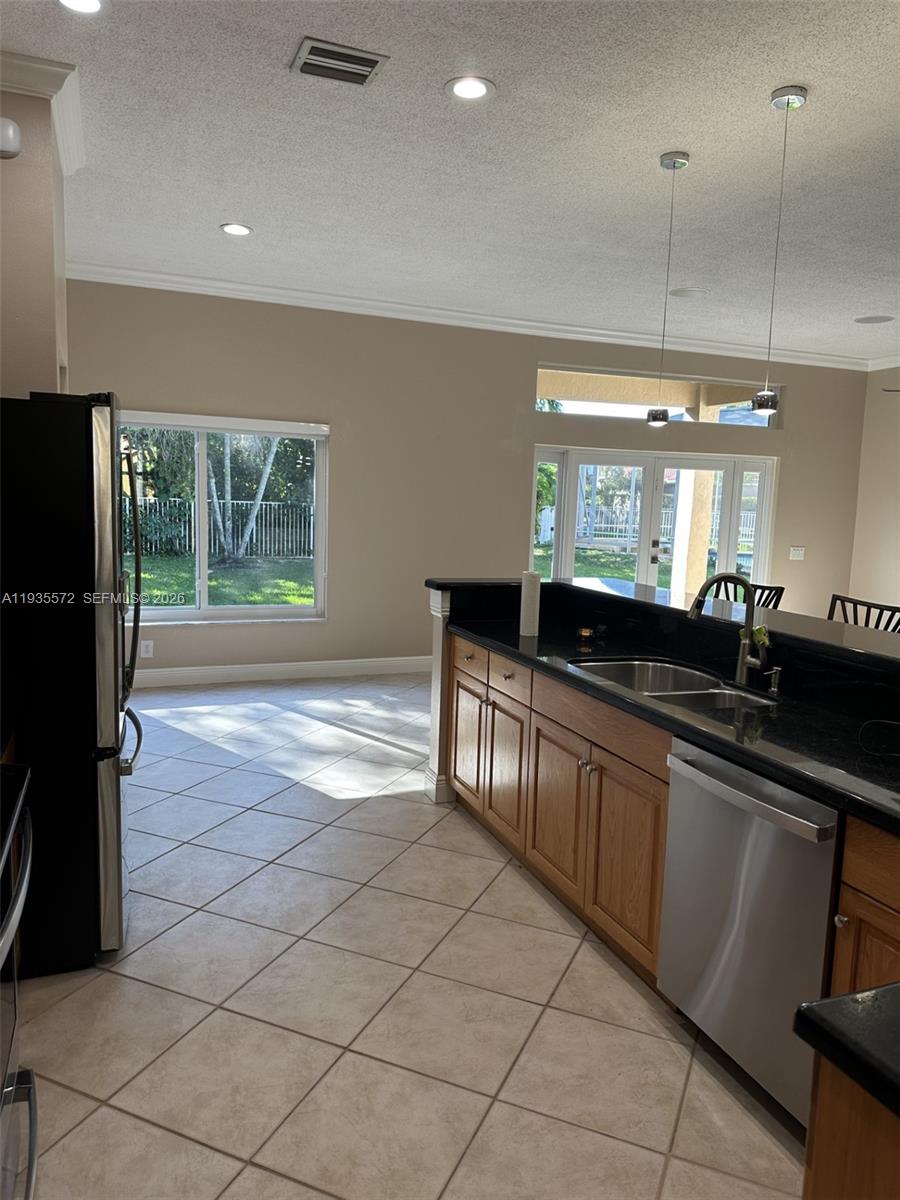 The Ridges Weston, FL 33331 - Photo 8 of 28 a kitchen with granite countertop a sink and a refrigerator