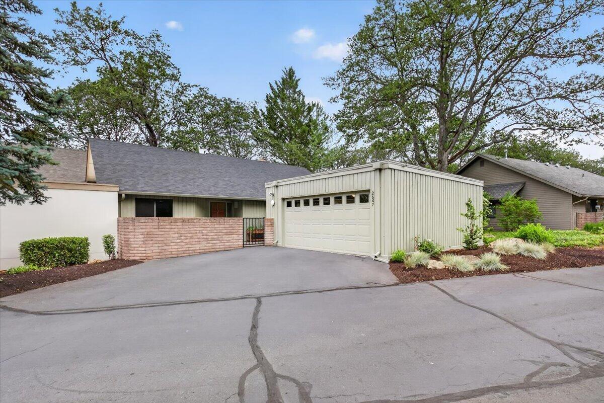 a view of a house with a yard and garage