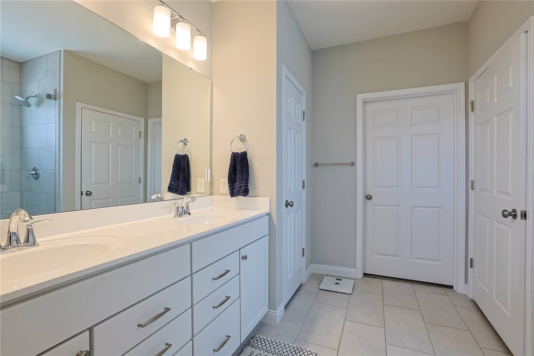 5013 Arena Court Hamilton, OH 45011 - Photo 22 of 41 This spacious bathroom offers dual vanities, providing ample counter space and storage.