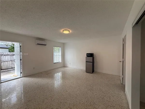 an empty room with windows and closet
