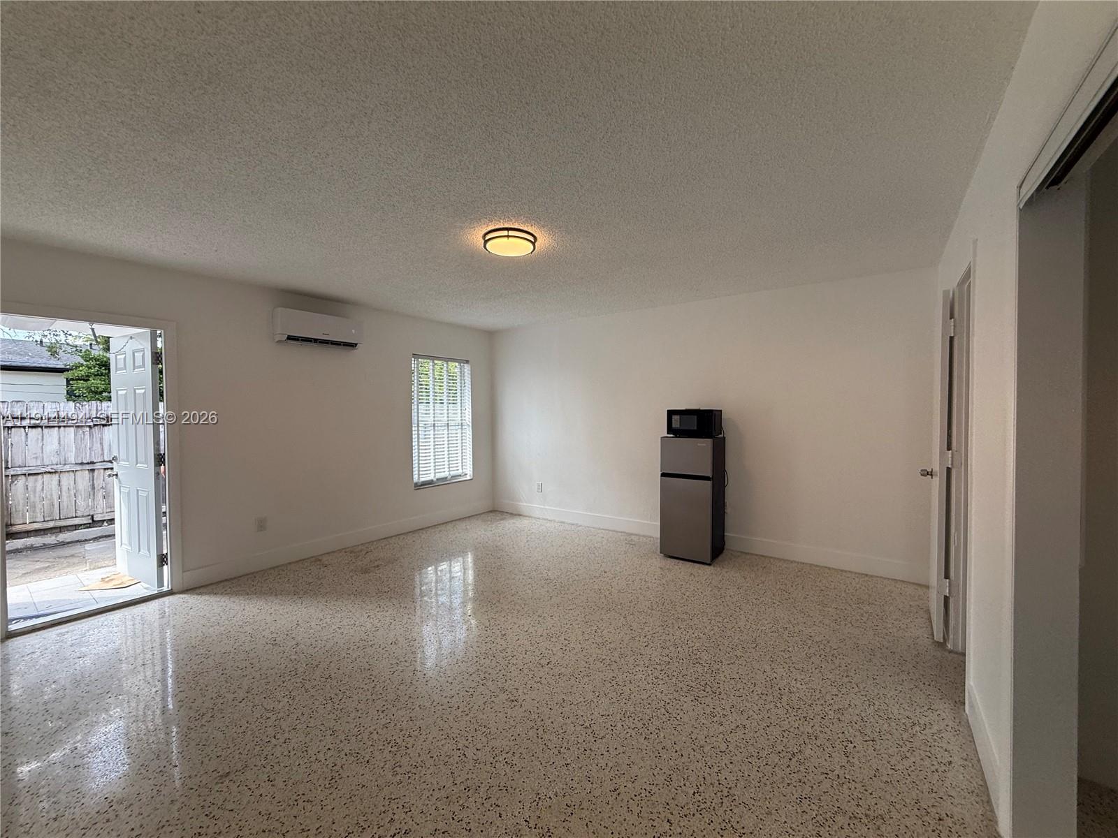 3144 Northwest 29th Street, Unit 2 Miami, FL 33142 - Photo 4 of 6 an empty room with windows and closet