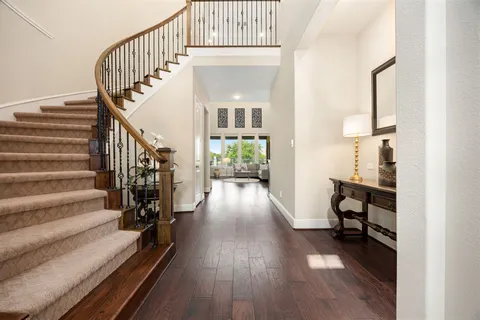 a view of entryway and hall with wooden floor
