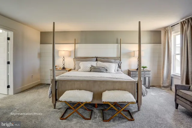 a bedroom with a bed a table and chair