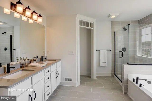 a spacious bathroom with double vanity a and a shower