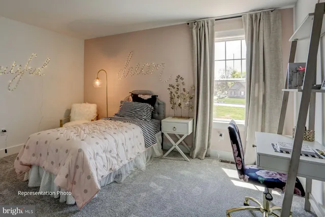 a bedroom with a bed and large windows