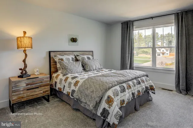 a bed sitting in a bedroom next to a window