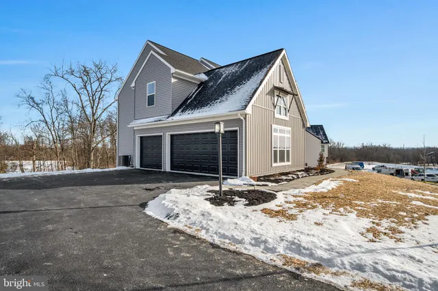 a view of a house with snow on the road
