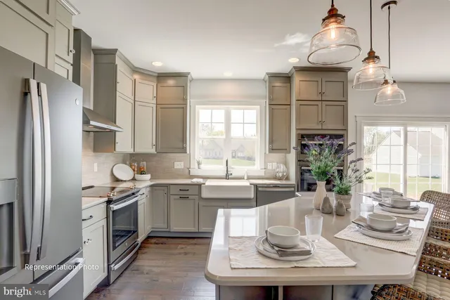 a kitchen with a sink stove and refrigerator