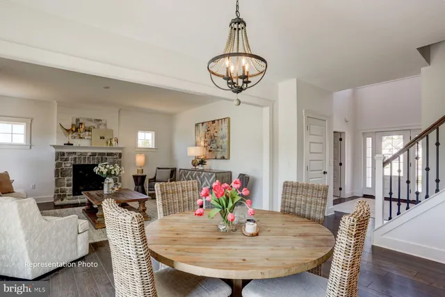 a view of a dining room with furniture a chandelier and wooden floor
