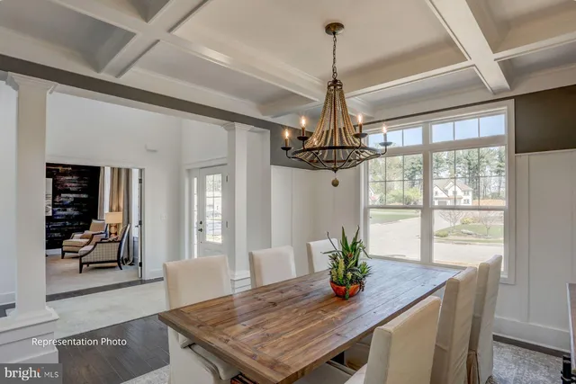 a view of a dining room with furniture wooden floor and chandelier