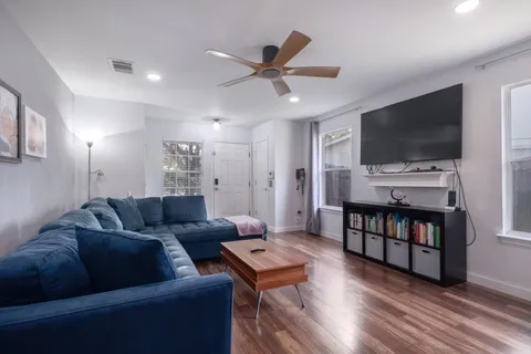 a kitchen with a table chairs microwave and cabinets