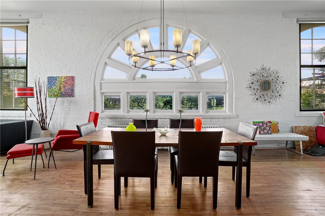 52 Webster Avenue, Unit 30 New Rochelle, NY 10801 - Photo 1 of 1 Open concept dining area, hardwood floors and large sunburst window letting in lots of light
