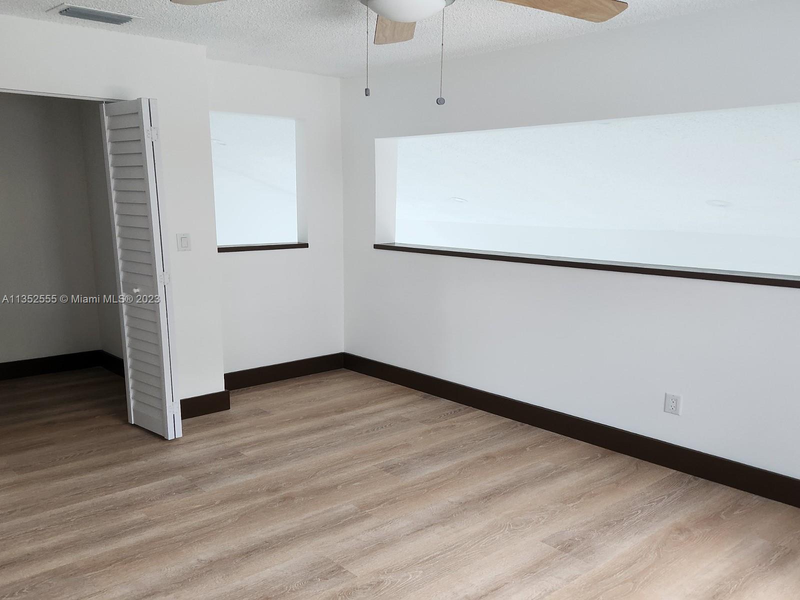 11111 Southwest 147th Court Miami, FL 33196 - Photo 11 of 20 a view of empty room with wooden floor