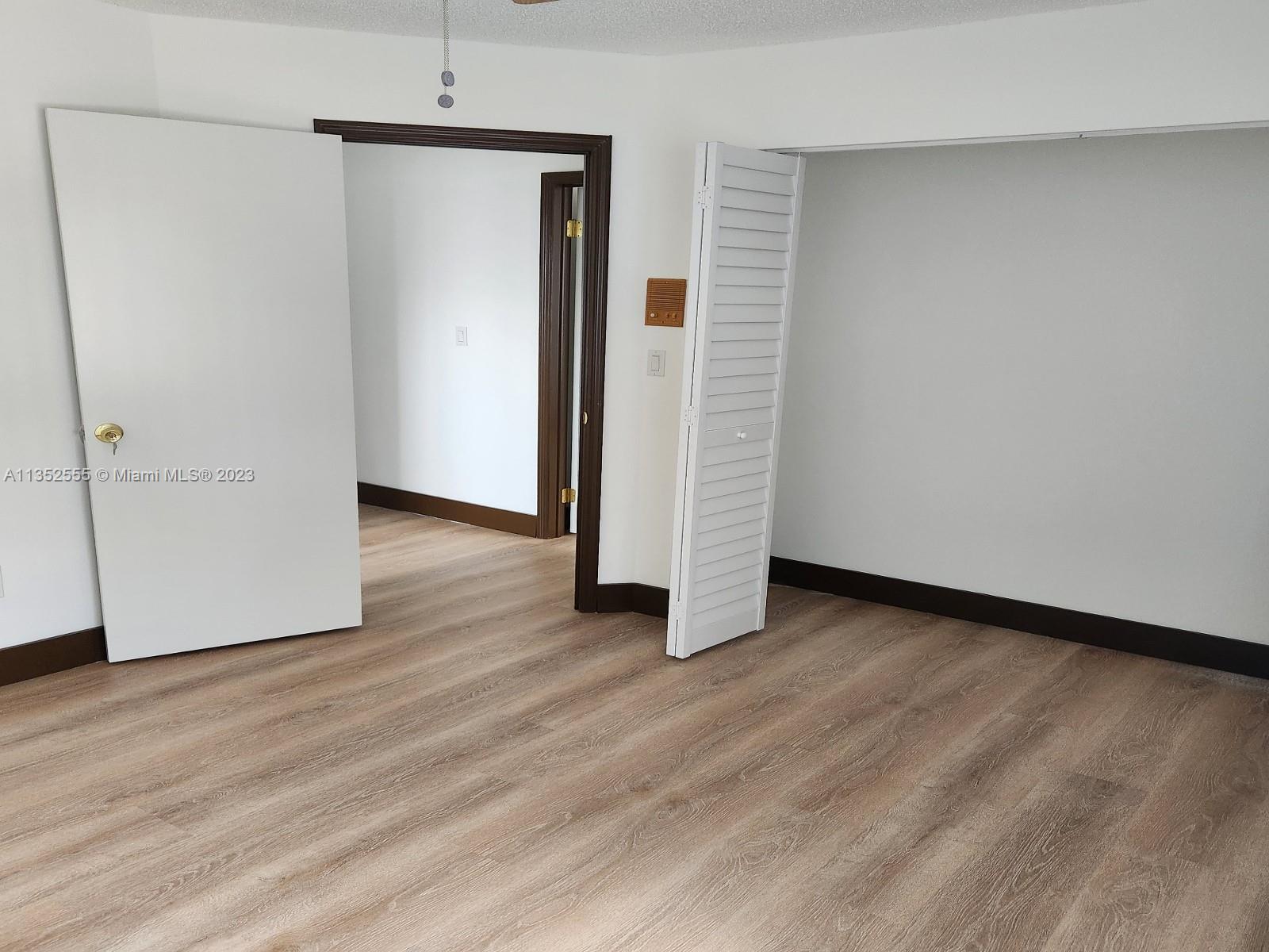 11111 Southwest 147th Court Miami, FL 33196 - Photo 16 of 20 an empty room with wooden floor and closet
